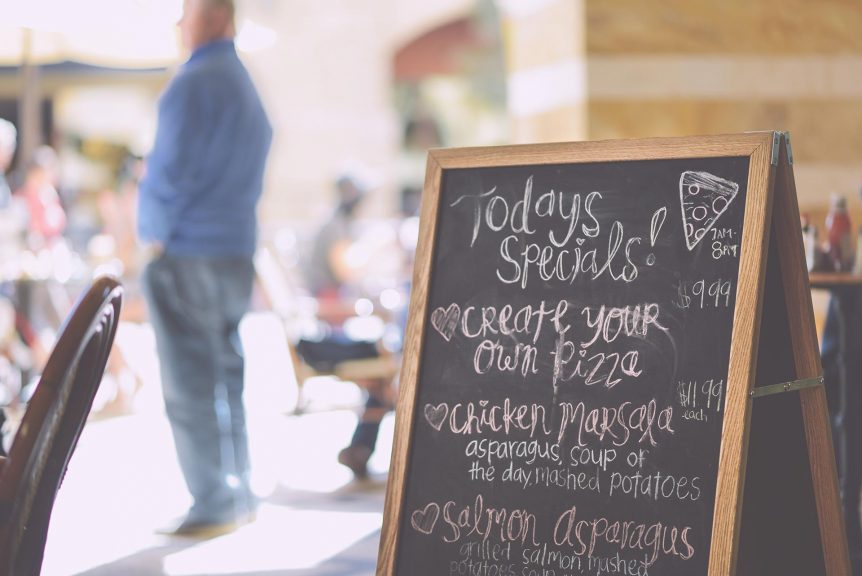 A chalk board menu out front of a restaurant