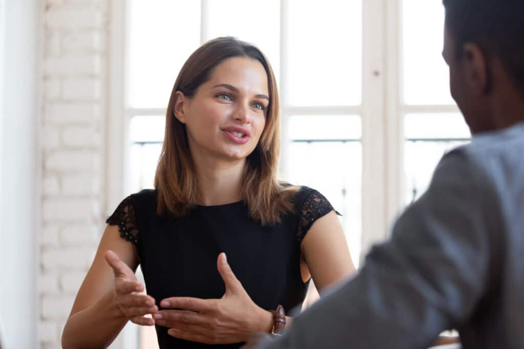 Happy pleasant young female financial advisor lawyer explaining contract details. Young woman explaining things to customer