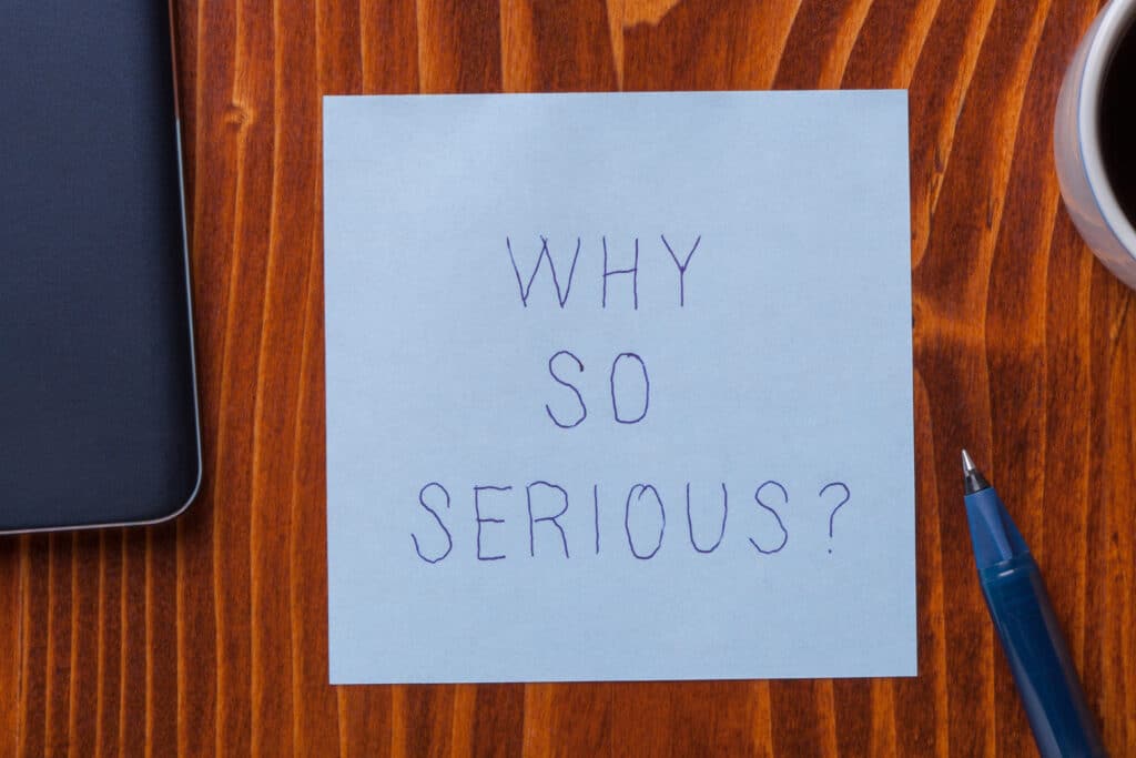 Sticky note with text why so serious A note on a desk with the words "why so serious?" written on it