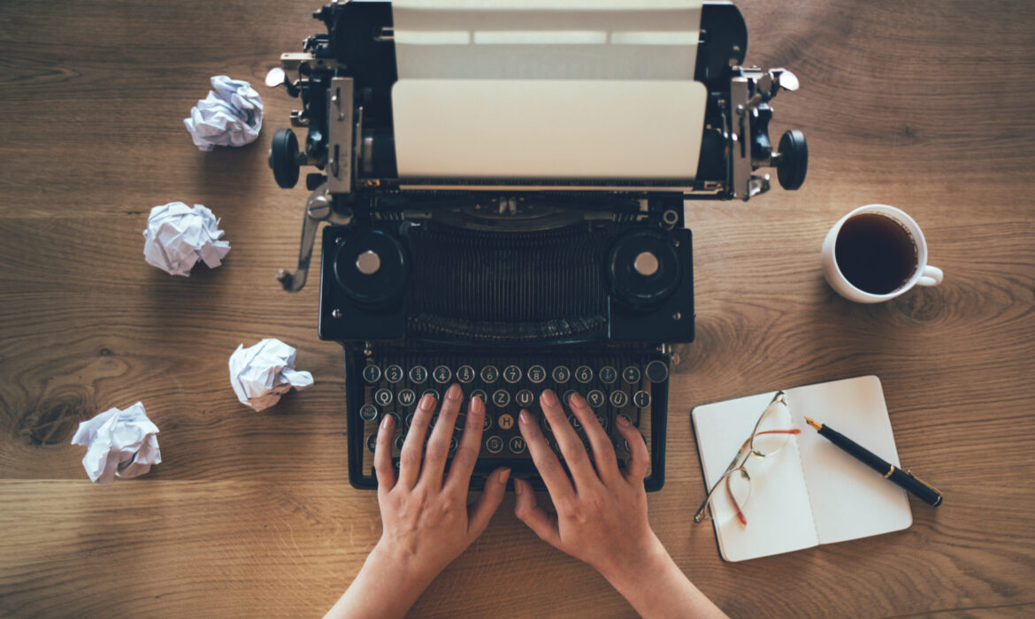 Person typing on old fashioned typewriter