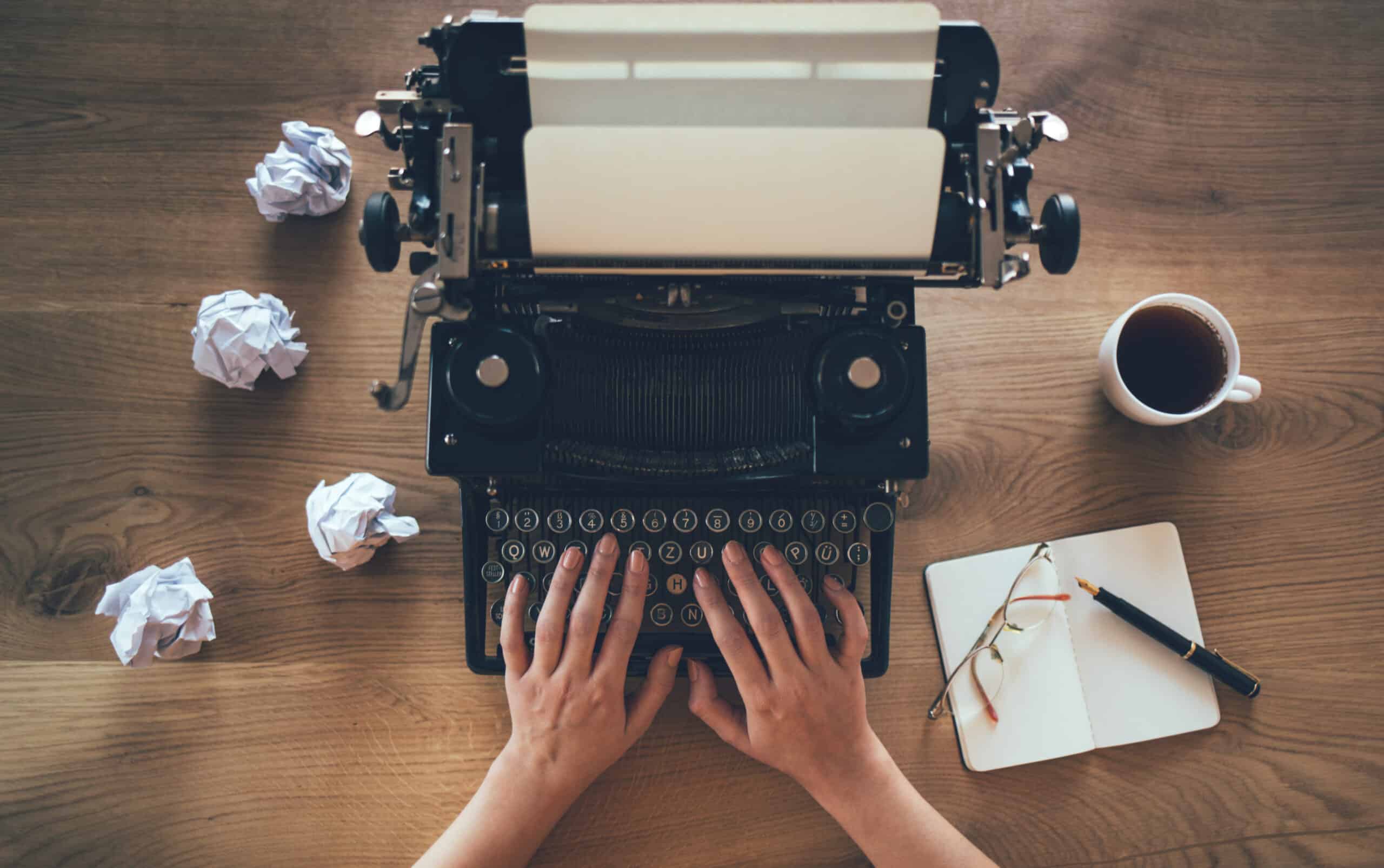 Person typing on old fashioned typewriter