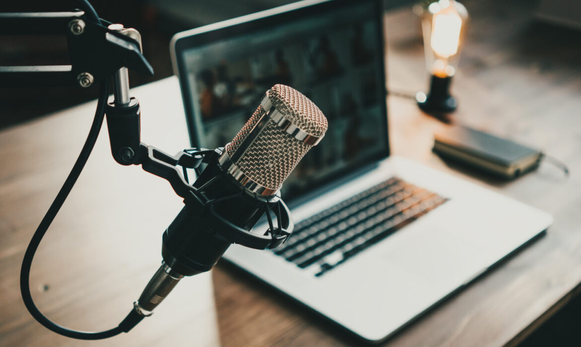podcast microphone in front of a laptop