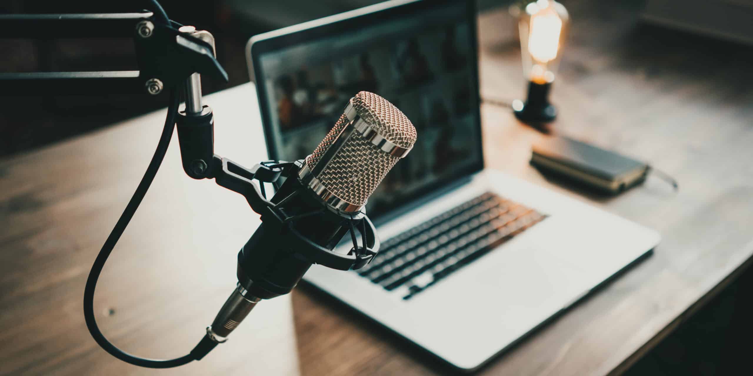 podcast microphone in front of a laptop